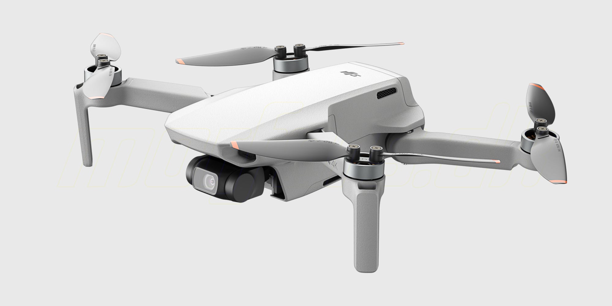 DJI Mini 4K drone med udfoldede arme og propeller set forfra på en hvid baggrund.